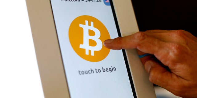 File photo. A bitcoin ATM machine is shown at a restaurant in San Diego, California.