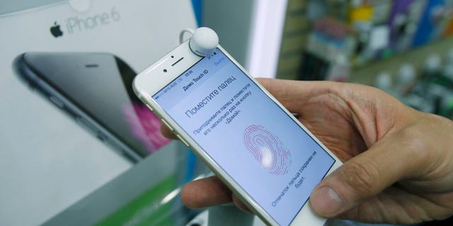 A man holds an iPhone 6 in a mobile phone shop in Moscow.