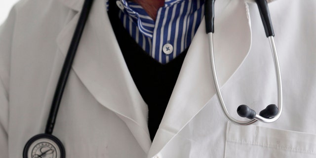 A photo illustration shows a French general practitioner with a stethoscope in a doctor's office in Bordeaux January 7, 2015. French physicians protest against a new health reform bill that would introduce a third party payment system. Picture taken January 7, 2015. REUTERS/Regis Duvignau (FRANCE - Tags: HEALTH POLITICS) - RTR4OCXQ