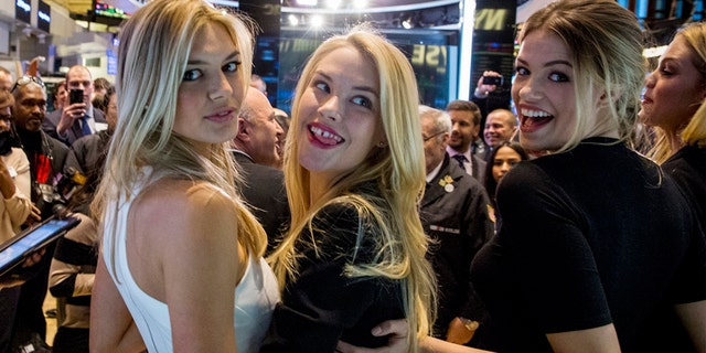 Sports Illustrated swimsuit models Kelly Rohrbach, Ashley Smith (2nd R), and Hailey Clauson (R) pose together on the floor of the New York Stock Exchange, February 6, 2015.