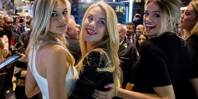Sports Illustrated swimsuit models Kelly Rohrbach, Ashley Smith (2nd R), and Hailey Clauson (R) pose together on the floor of the New York Stock Exchange, February 6, 2015.