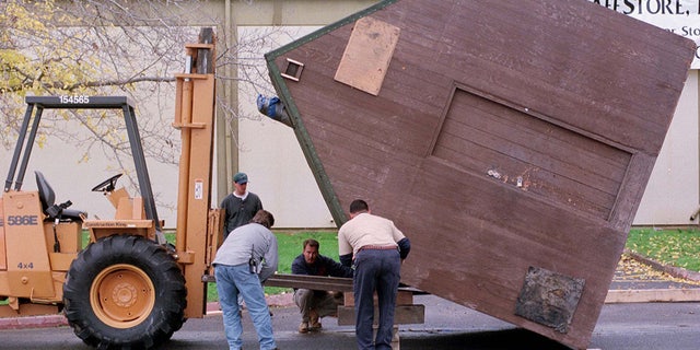 Workers prepare to right the cabin home of Unabomber suspect Theodore Kaczynki on December 5 after it was unloaded from a truck at the former Mather Air Force Base in Rancho Cordova, California. The 10 x 12-foot cabin was moved by truck from Montana by the defense to exhibit to jurors during the upcoming trial.
UNABOMBER - RTR9DCZ