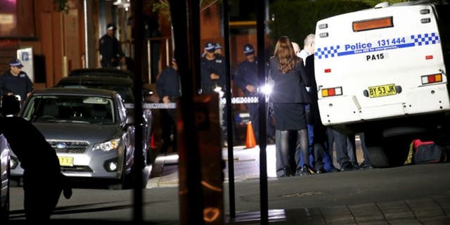 Oct. 2, 2015: Police stand guard and inspect the area outside the New South Wales state police headquarters located in the Sydney suburb of Parramatta, Australia.