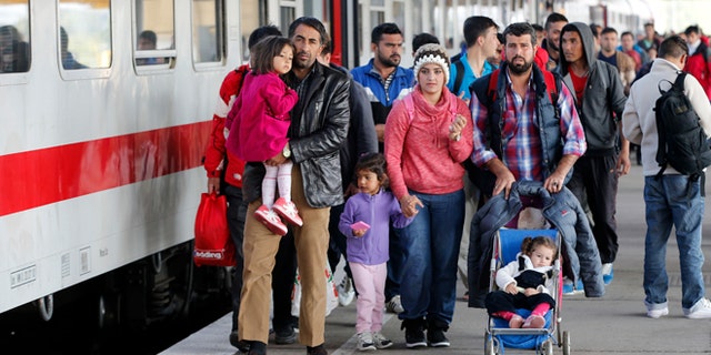 Oct. 5, 2015: Refugees from Syria walk along a platform after arriving from Salzburg, Austria, at Schoenefeld railway station in Berlin, Germany.
