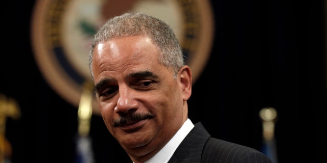 U.S. Attorney General Eric Holder looks on during a special naturalization ceremony at the Department of Justice in Washington May 28, 2013. REUTERS/Kevin Lamarque (UNITED STATES - Tags: POLITICS) - RTX10480