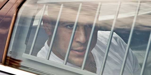 New England Patriots tight end Aaron Hernandez is led out of the North Attleborough police station after being arrested June 26, 2013. Hernandez, a 23-year-old rising football star with the New England Patriots, was arrested by police in a murder investigation and fired by the team on Wednesday, another blot on the National Football League's tightly protected image.