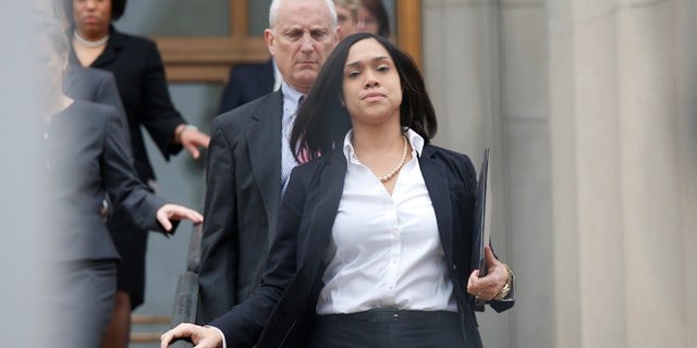 May 1, 2015: Baltimore state attorney Marilyn Mosby walks down the stairs followed by her legal team to speak on Freddie Gray case.