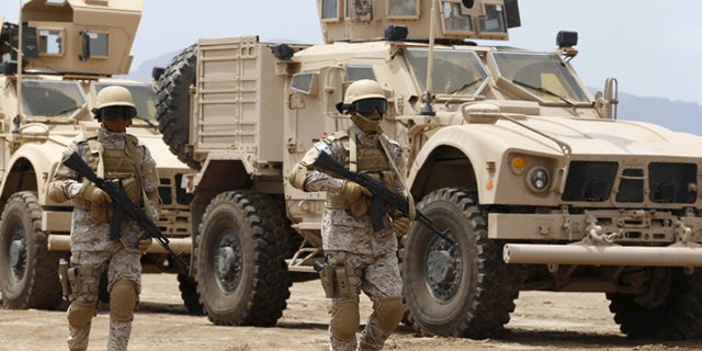 Sept. 28, 2015: Saudi troops walk at their base in Yemen's southern port city of Aden.