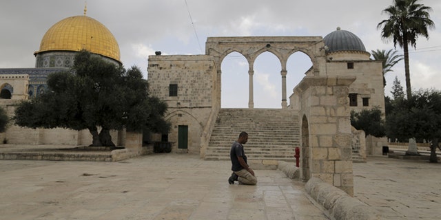 Oct. 26, 2015: A Muslim man prays near the Dome of the Rock on the compound known to Muslims as the Noble Sanctuary and to Jews as Temple Mount in Jerusalem's Old City.