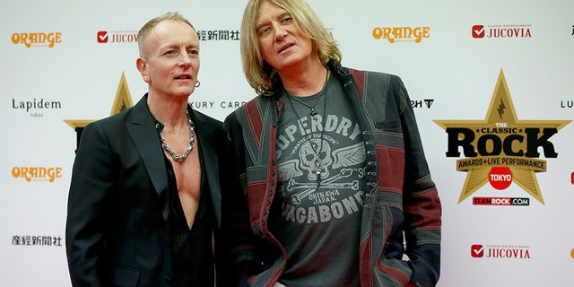 Def Leppard lead singer Joe Elliott (R) and lead guitarist Phil Collen pose on the red carpet at the 2016 Classic Rock Roll of Honour awards in Tokyo, Japan, November 11, 2016.
