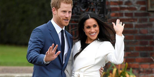 Britain's Prince Harry poses with Meghan Markle in the Sunken Garden of Kensington Palace, London, Britain, November 27, 2017.