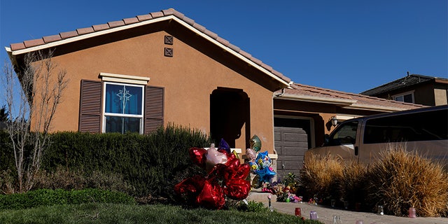 Balloons, stuffed animals and flowers are seen in the front yard of the home of David Allen and Louise Anna Turpin in Perris, California, U.S.,January 24, 2018.