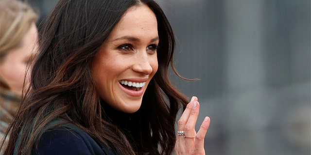 Meghan Markle, fiancee of Britain's Prince Harry, waves as she arrives for a visit to Edinburgh, Scotland February 13, 2018.