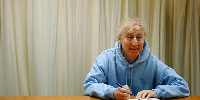 Actor and author Gene Wilder poses as he autographs his new book "The Woman Who Wouldn't" during a book signing session in New York March 26, 2008.
