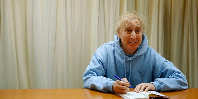 Actor and author Gene Wilder poses as he autographs his new book "The Woman Who Wouldn't" during a book signing session in New York March 26, 2008.