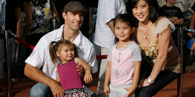 Olympic figure skating champion Kristi Yamaguchi (R) poses with husband Bret Hedican (L) and daughters Emma (2nd L) and Keara at the world premiere of Disney-Pixar's film "Wall-E" in Los Angeles, California June 21, 2008.