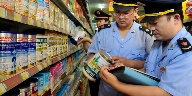 Local industry and commerce administrative bureau personnel check Sanlu formula milk products at a supermarket in Zaozhuang, Shandong province, September 12, 2008. China's Health Ministry has launched a nationwide investigation into the infant kidney stone case related with domestic milk powder, Sanlu formula, and asked all local health agencies to report relevant cases immediately, Xinhua News Agency reported. REUTERS/China Daily (CHINA). CHINA OUT. NO COMMERCIAL OR EDITORIAL SALES IN CHINA. - RTX8P0V