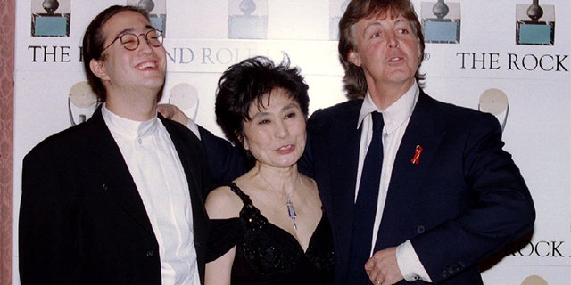 Former Beatle Paul McCartney, right, laughs with Yoko Ono and Sean Lennon after inducting fellow former Beatle John Lennon into the Rock and Roll Hall of Fame in New York on Jan. 20, 1994. (Reuters)