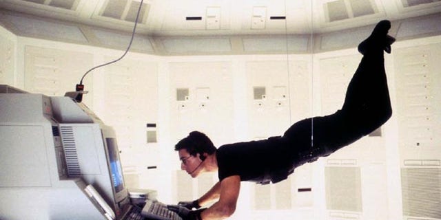 Actor Tom Cruise is shown as he portrays "Agent Ethan Hunt" in the adventure thriller film, "Mission Impossible."