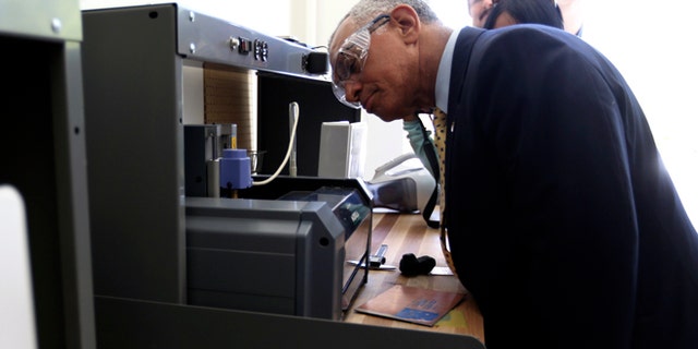 NASA Administrator Charles Bolden looks over a 3D printer during a tour of the Ames Research Center at Moffett Field in Mountain View, California May 24, 2013.