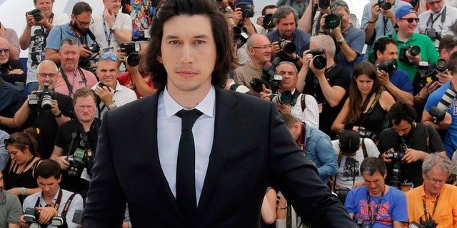 Adam Driver poses during a photocall for the film