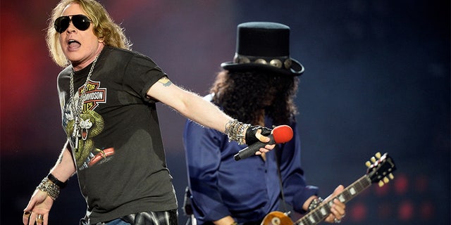 Axl Rose (L), and Slash of rock band Guns N' Roses.