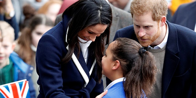 Britain's Prince Harry and his fiancee Meghan Markle meet local school children during a walkabout on a visit to Birmingham, Britain, March 8, 2018.
