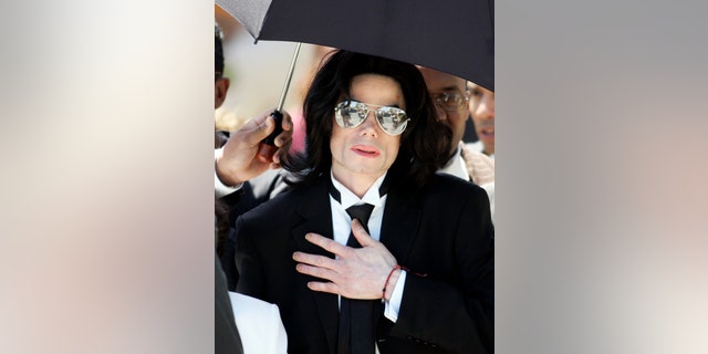 Michael Jackson leaves the Santa Barbara County Courthouse after being found not guilty on all ten counts of child molestation in Santa Maria, California in this June 13, 2005 file photo. Fans, museums and some members of Michael Jackson's family will mark Friday's one-year anniversary of the singer's death on June 25, 2010 with special exhibits, tributes and flash mob dances from Manila to Manhattan. REUTERS/Gene Blevins/Files (UNITED STATES - Tags: ENTERTAINMENT OBITUARY) - RTR2FLYL