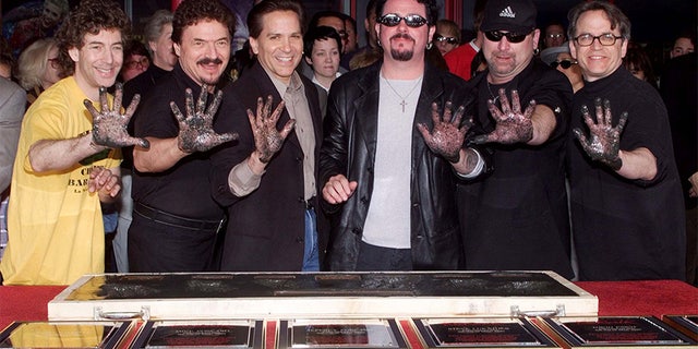 Members of the rock band Toto pose after placing their handprints in cement as they were inducted into Hollywood's RockWalk May 4 in Hollywood. The band, best know for songs such as "Rosanna" and "Hold The Line" were honored for their contributions to the rock n' roll artform. Shown (L-R) are Simon Phillips, Bobby Kimball, Mike Porcaro, Steve Lukather, David Paich and Steve Porcaro.
**DIGITAL IMAGE** - PBEAHULUKEG