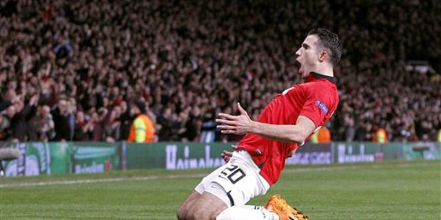 Manchester United's Robin van Persie celebrates scoring his side's third goal and his hat-trick, during the Champions League, Round of 16, second leg match against Olympiakos, at Old Trafford, Manchester, England, Wednesday March 19, 2014. (AP Photo /PA, Peter Byrne) UNITED KINGDOM OUT NO SALES NO ARCHIVE