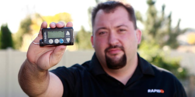 Jay Radcliffe shows off a Medtronic Corp insulin pump at his home in Meridian, Idaho.