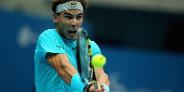 BEIJING, CHINA - OCTOBER 06: Rafael Nadal of Spain returns a shot against Novak Djokovic of Serbia during the Men's Single Final on night day of the China Open at the China National Tennis Center on October 6, 2013 in Beijing, China. (Photo by Feng Li/Getty Images)