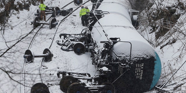Feb. 13: Emergency personnel examine the wreckage of a train derailment near Vandergrift, Pennsylvania. A 120-car Norfolk Southern Corp train carrying heavy Canadian crude oil derailed and spilled in western Pennsylvania on Thursday, adding to a string of recent accidents that have prompted calls for stronger safety standards.