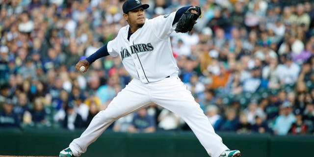 Seattle Mariners starting pitcher Felix Hernandez throws against the Texas Rangers in the first inning of a baseball game, Saturday, April 18, 2015, in Seattle. (AP Photo/Ted S. Warren)