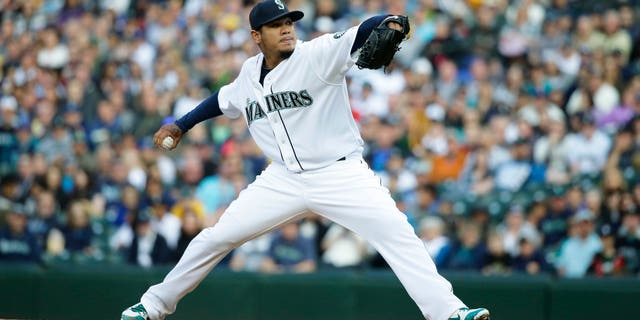 Seattle Mariners starting pitcher Felix Hernandez throws against the Texas Rangers in the first inning of a baseball game, Saturday, April 18, 2015, in Seattle. (AP Photo/Ted S. Warren)