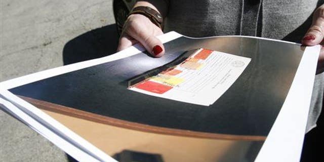 Cara Smith, the chief of policy and communications for the Cook County, Ill., Sheriff's department, holds a photo of a rape kit on Sept. 26, 2013, in Robbins, Ill.