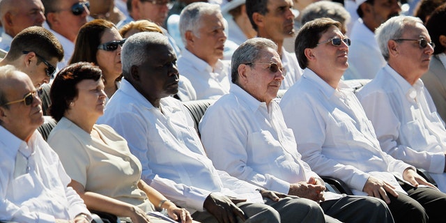 HAVANA, CUBA - MARCH 28:  Cuban President Raul Castro (C) listens as Pope Benedict XVI conducts a mass at Havana's Revolution Square on the last day of his three day visit on March 28, 2012 in Havana, Cuba. Fourteen years after Pope John Paul II visited Cuba, Pope Benedict is making his first trip to the communist country.  (Photo by Joe Raedle/Getty Images)