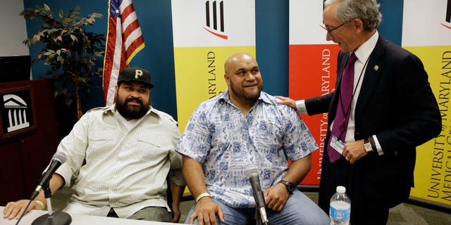 Sept. 17, 2014: Chris Kemoeatu, left, and his brother Ma'ake chat with Dr. Matthew Weir after a news conference at the University of Maryland Medical Center in Baltimore.