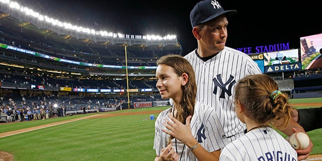 New York Yankees designated hitter Alex Rodriguez (13) gathers his daughters, Natasha, left, and Ella,  before leaving the field after his final baseball game as a Yankee player, against the Tampa Bay Rays at Yankee Stadium in New York, Friday, Aug. 12, 2016. The Yankees won 6-3. (AP Photo/Kathy Willens)