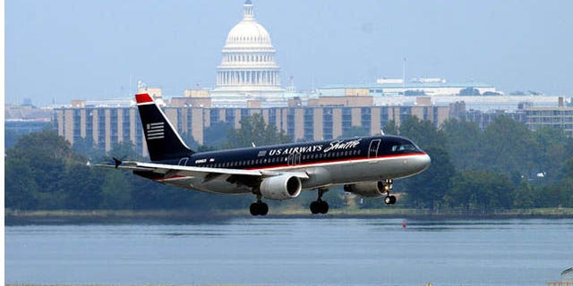 This file photo shows a U.S. Airways plane landing at Reagan National Airport.