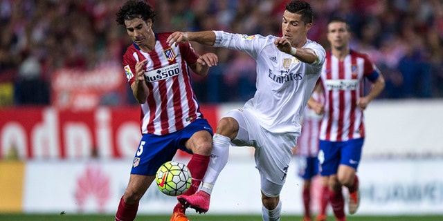 MADRID, SPAIN - OCTOBER 04: Cristiano Ronaldo (R) of Real Madrid CF competes for the ball with Tiago Mendes (L) of Atletico de Madrid during the La Liga match between Club Atletico de Madrid and Real Madrid CF at Vicente Calderon Stadium on October 4, 2015 in Madrid, Spain.  (Photo by Gonzalo Arroyo Moreno/Getty Images)