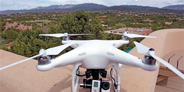 The remote controlled DJI Phantom drone with an attached GoPro 3 camera used by Brian Tercero of Keller Williams Realty used to create a high definition video of a property is seen in Santa Fe, N.M. on April 18, 2014. (AP Photo/The Santa Fe New Mexican, Clyde Mueller)