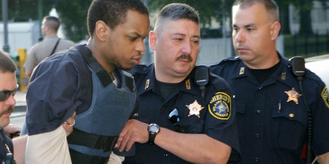Abdulhakim Muhammad, second from left, is escorted to the Pulaski County Courthouse in Little Rock, Ark.