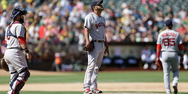 Boston Red Sox pitcher Eduardo Rodriguez, center, reacts after Oakland Athletics' Marcus Semien hit a single, breaking up a no hitter in the eighth inning of a baseball game, Sunday, Sept. 4, 2016, in Oakland, Calif. (AP Photo/Ben Margot)