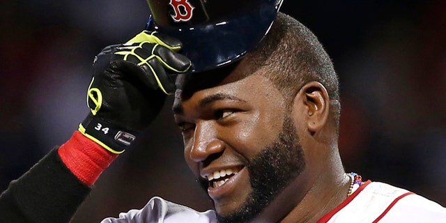Aug. 20, 201: Boston Red Sox designated hitter David Ortiz tips his cap while standing on third base during a baseball game.