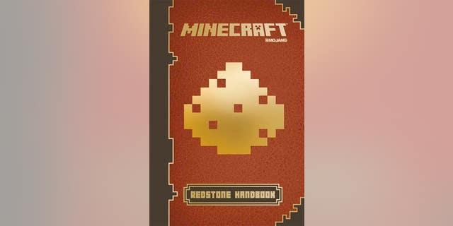 This photo provided by Scholastic shows the cover of the book, "Minecraft: Essential Handbook."
