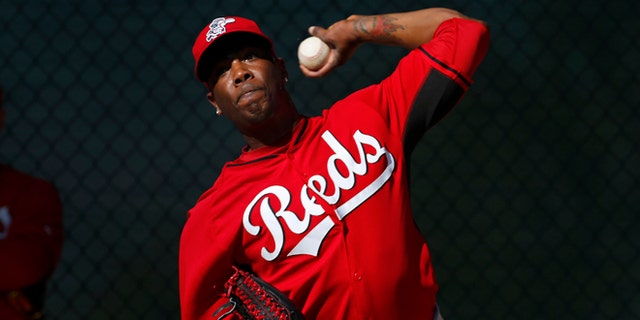 FILE - In this Feb. 15, 2014, file photo, Cincinnati Reds relief pitcher Aroldis Chapman throws during spring training baseball practice in Goodyear, Ariz. Chapman, with two black eyes, has returned to the Reds' clubhouse four days after being hit in the face by a line drive. The 26-year old left-hander had surgery at Banner Good Samaritan Medical Center, Thursday, March 20, 2014, to repair a broken bone above his left eye. (AP Photo/Paul Sancya, File)