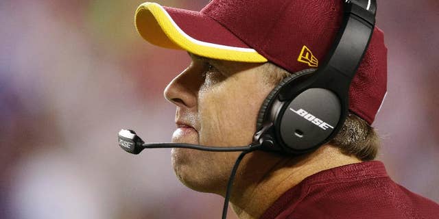 FILE - In this Sept. 25, 2014, file photo, Washington Redskins head coach Jay Gruden looks up at the scoreboard during the second half of an NFL Thursday night football game against the New York Giants in Landover, Md. Gruden knew there was work to do when he took over a Redskins team than went 3-13 last year.(AP Photo/Patrick Semansky, File)