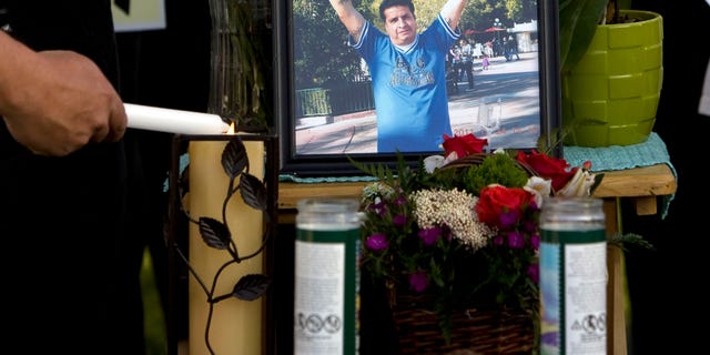 May 5, 2013: A mourner light candles at a makeshift memorial before a news conference by the family to discuss the death of Ricardo Portillo, who passed away after injuries he sustained after an assault by a soccer player at a soccer game he was refereeing on April 27, in Salt Lake City.