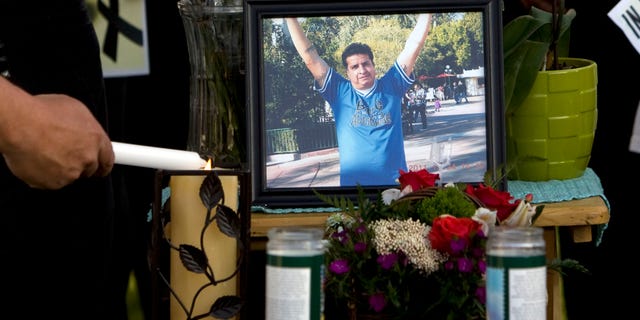 May 5, 2013: A mourner light candles at a makeshift memorial before a news conference by the family to discuss the death of Ricardo Portillo, who passed away after injuries he sustained after an assault by a soccer player at a soccer game he was refereeing on April 27, in Salt Lake City.